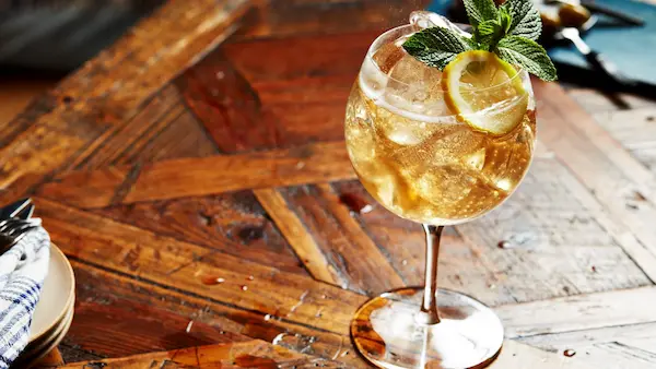 whisky con ginger ale servido con hielo en vaso alto