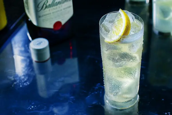 trago de whisky con limón y soda en vaso con hielo refrescante